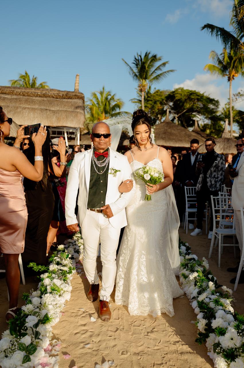 Wedding ceremony setup with a white floral arch in Mauritius