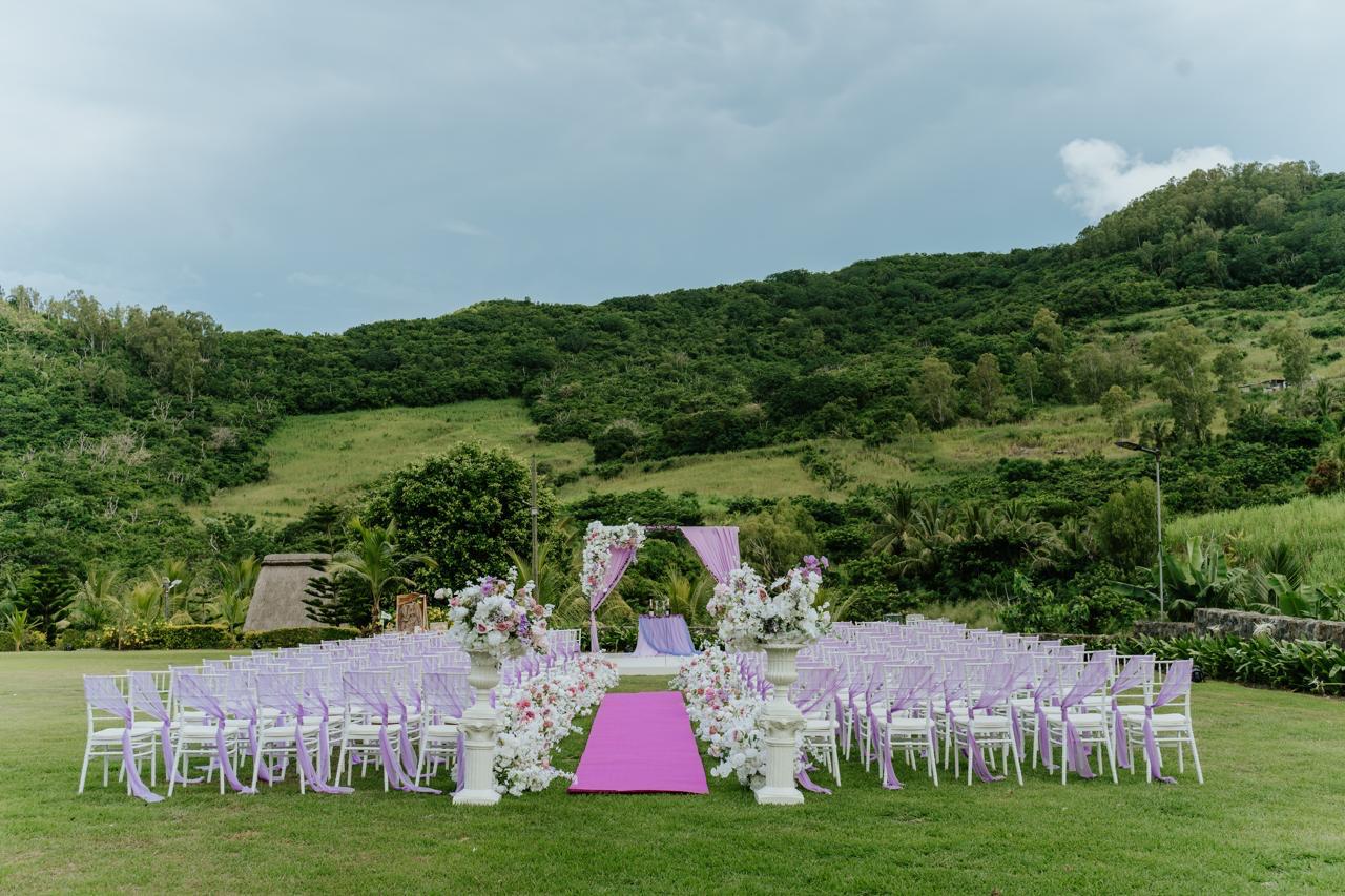 Outdoor ceremony aisle lined with florals