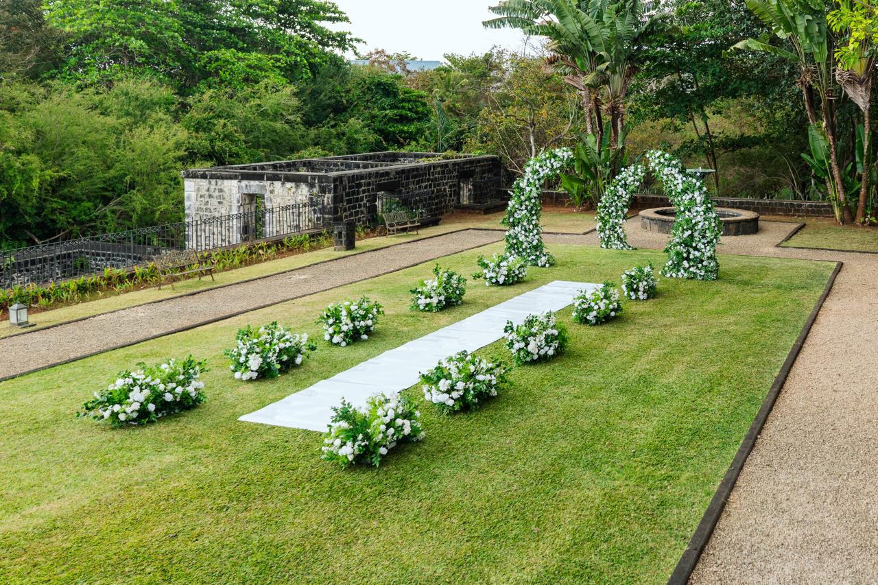 Floral arches beside a garden fountain